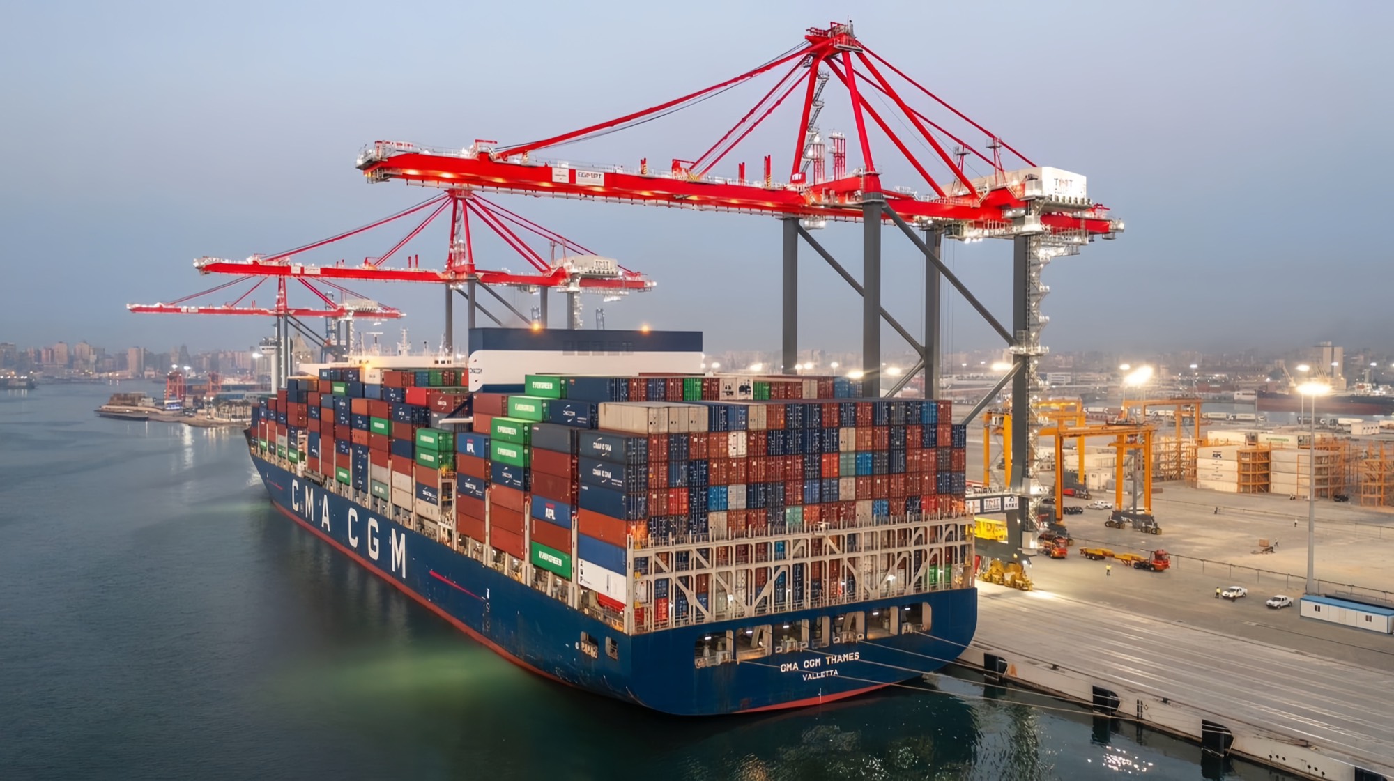 Container ship berthed under ship-to-shore cranes